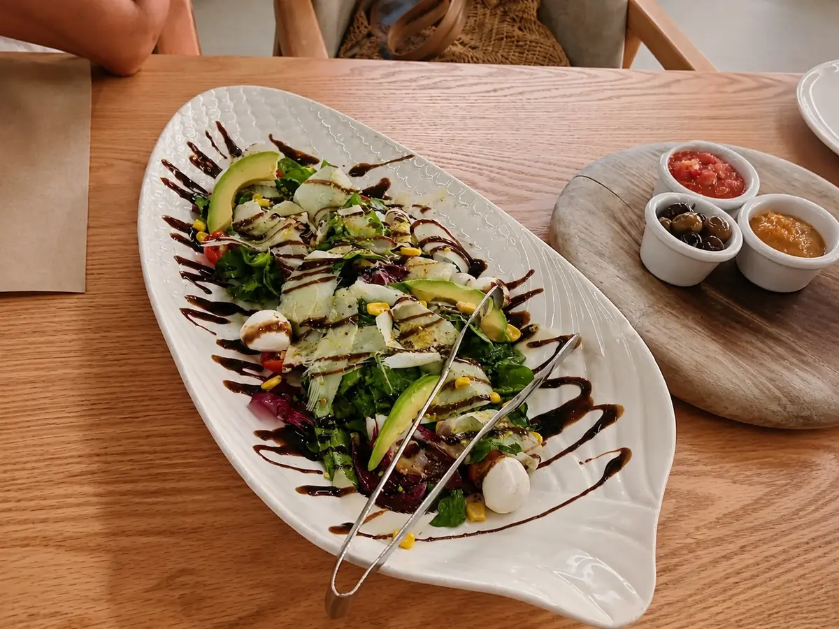Mixed salad with avocado, cheese and balsamic glaze