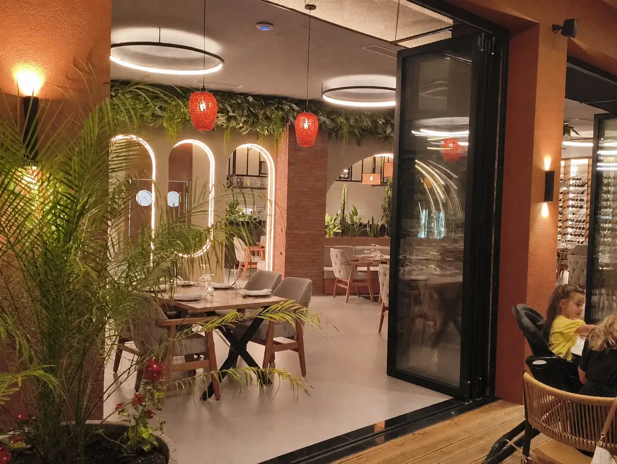 The warmly lit entrance and dining room at Pescato